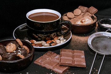 Chocolate chip cookies, dark and white chocolate bar, small bowl of oatmeal and nuts. International Chocolate Day.