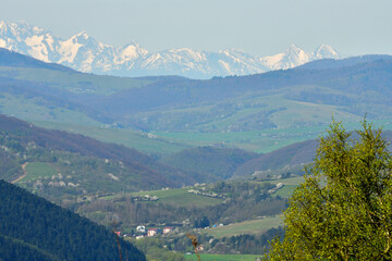 Fototapeta premium Surrounding valleys and mountains and view from of the high peaks of snow-capped mountains 