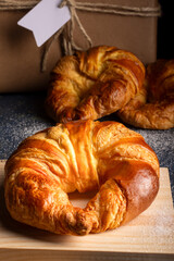 Wonderful Close-up of freshly baked croissants placed on a wooden board.
