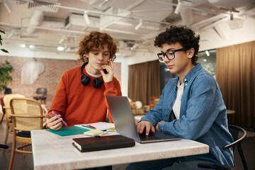 Boys teenagers working together in modern office