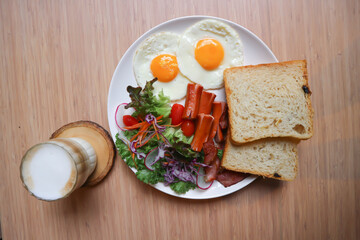breakfast or bread with sunny side up egg, sausage and vegetable and hot coffee