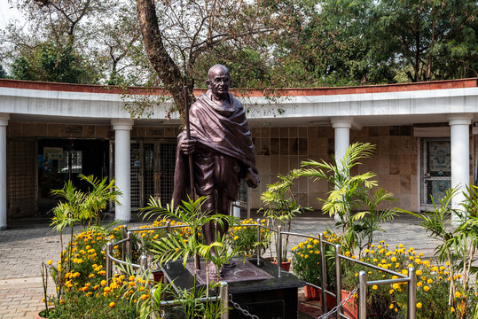 Raj Ghat in Delhi, India,.Mahatma Gandhi statue near the memorial situated in the place where the famous Indian leader was cremated