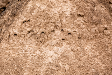 Moon Canyon Almaty, Kazakhstan. Texture of yellow clay with cracks and holes