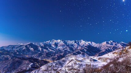 The Magnificent Snow-Capped Mountains Against the Blue Sky Background at Night in Rizhao Jinshan. A Stunning Natural Sight that Evokes Peace and Awe. The Beauty of Nature in Its Pristine Form.