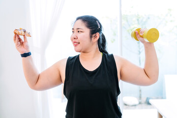fat woman choosing dessert over workout. fat exerciser ignored dumbbell turning to unhealthy food...