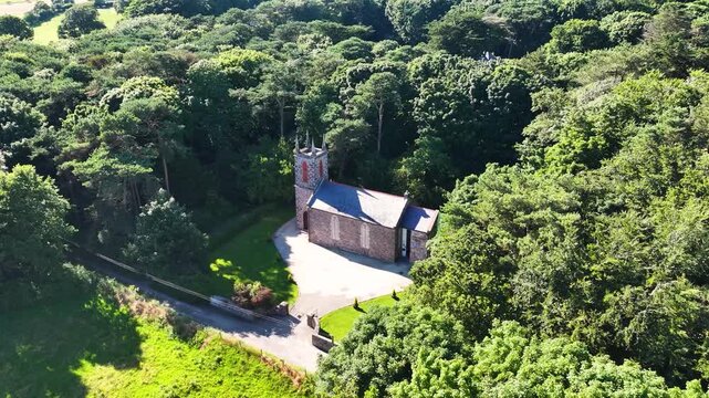 Aerial View of Old Cushendun Church on the Irish Sea Co Antrim Northern Ireland on a sunny day with a blue sky