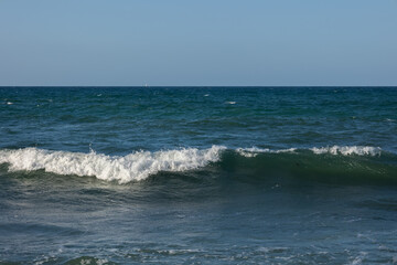 Impressive image of the sea in which we can see the formation of a wave which gives a unique touch to the landscape and a beautiful blue sky