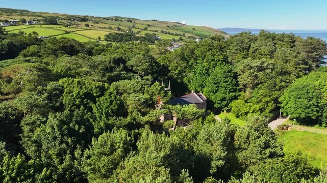 Aerial View of Old Cushendun Church on the Irish Sea Co Antrim Northern Ireland on a sunny day with a blue sky