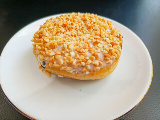 photo of peanut donuts on a white round plate