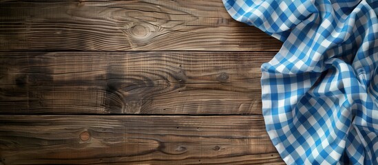 A brown wooden table with a blue and white chequered tablecloth, evoking a retro, vintage picnic feel. Perfect for Italian menu designs, kitchen textiles, and country-themed backgrounds.