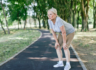 outdoor senior fitness jogging woman active sport exercise tired exhausted dehydration portrait...