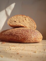 The bread is cut on the table. Fresh, warm bread baked in a bakery. Homemade bread. Background, place for text. The concept of a new harvest of grain and flour.