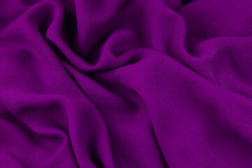 Purple fabric background. Purple cloth waves background texture. Purple fabric cloth textile material.