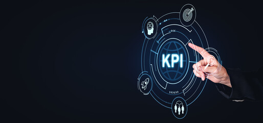 Business hand pointing at KPI hologram interface on dark background.