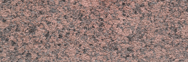 Granite texture. Natural pink granite with a grainy pattern. Stone background. Solid rough surface...