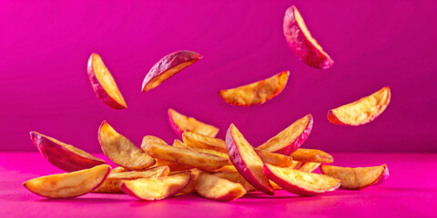 Falling Potato Wedges on Pink Background