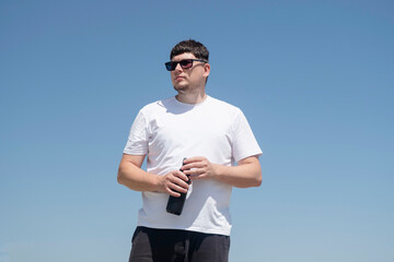 Fototapeta premium Sportive man workout drinking water from bottle