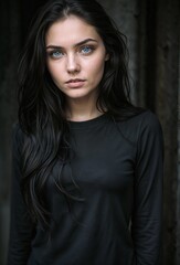 Portrait of a beautiful brunette girl in a black dress.