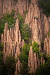 Majestic Pinnacles of Eroded Rock Surrounded by Lush Greenery in Serene Landscape