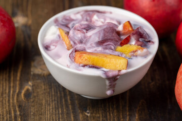natural yogurt in a white bowl with fruits