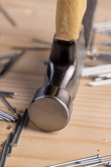 nails with small caps and an iron hammer on boards