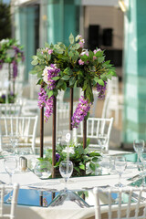 Beautifully Decorated Wedding Tables with Purple Flowers at Garden Event