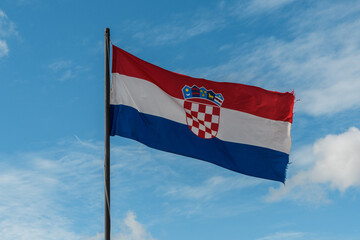 Croatia’s Colors Aloft. Croatian Pride: National Flag Waves Against Blue Sky