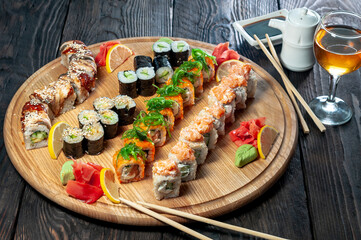 huge sushi set philadelphia deluxe on a round plate on a dark background