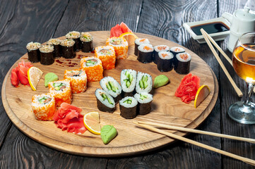 a large sushi set on a round board