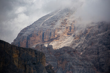 Majestic Mountain Peaks Shrouded in Clouds at Dusk in the Dolomites
