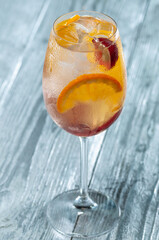 alcoholic cocktail in a glass on a silver background, vertical photo