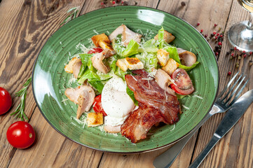 Caesar salad in the author's presentation on a green plate