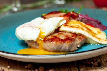Grilled steak with grilled cheese in a blue plate, macro photo