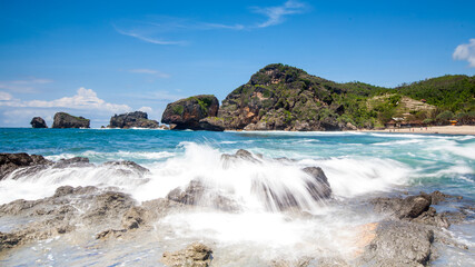 Water Splashes Rocks On The Beach