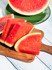 Watermelon slices on wooden cutting board, summer fruit