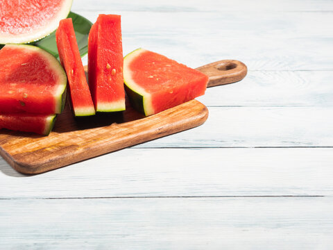 Seedless watermelon slices on wooden background, summer fruit
