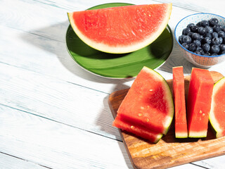 Seedless watermelon and blueberries on wooden background, summer fruit