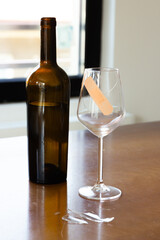 Broken glass of wine. Sadness after the breakup. Tape on the glass