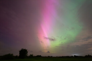 Captivating Aurora Borealis Illuminates Night Sky Over Rural Landscape in Vibrant Colors