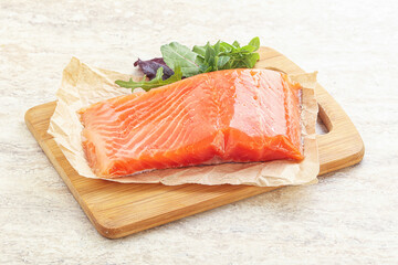 Raw salmon fillet over board