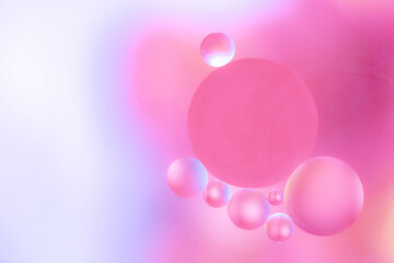 Abstract image with soft pink and purple bubbles of different sizes on a smooth gradient background. dreamy colors and delicate shapes for the presentation of cosmetic products 