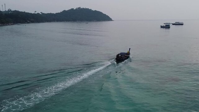 drone footage of fishing boat at north point beach in koh lipe thailand