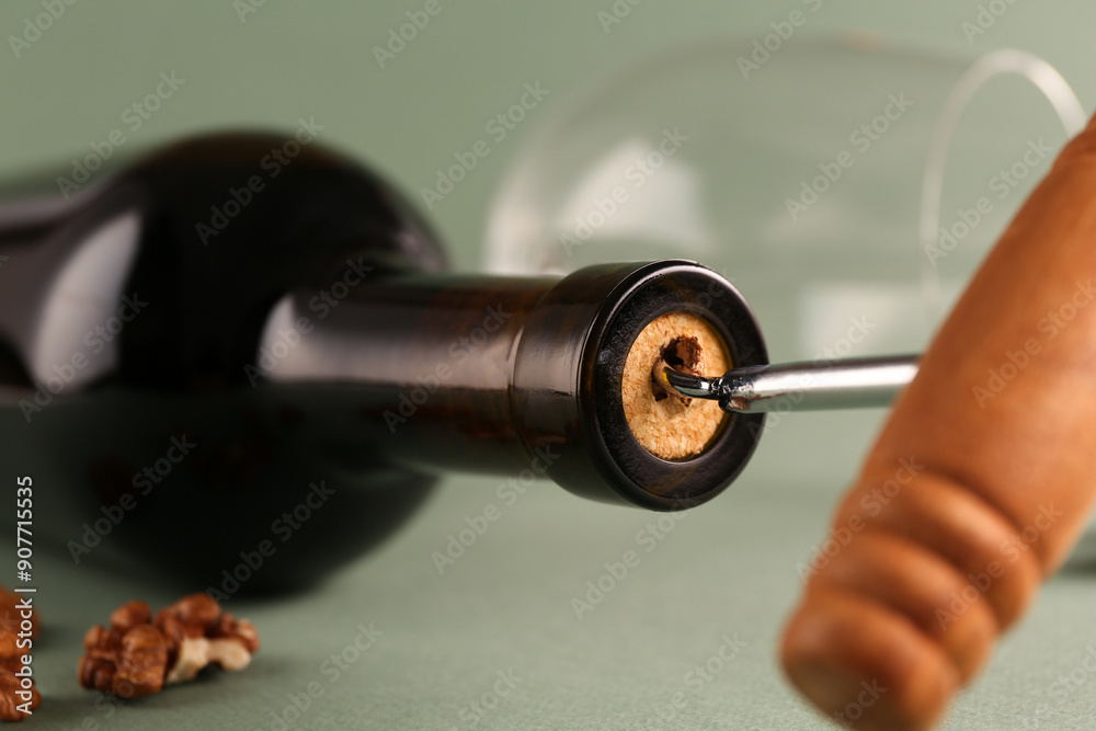 Poster Wine bottle with corkscrew on light grey background, closeup