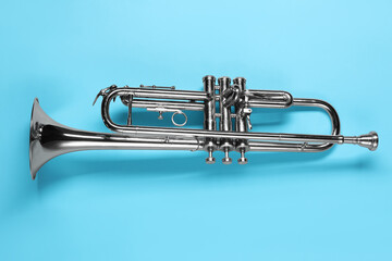 One trumpet on light blue background, top view