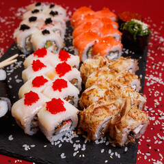 delicious set of rolls featuring fresh maki with salmon and tasty Philadelphia cheese, with shrimp and salmon, along with a delightful baked roll and two appetizing rolls with red and black caviar 