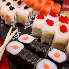 delicious set of rolls featuring fresh maki with salmon and tasty Philadelphia cheese, with shrimp and salmon, along with a delightful baked roll and two appetizing rolls with red and black caviar 