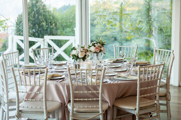 Elegant Wedding Table with Pastel Flowers and Greenery at Indoor Reception