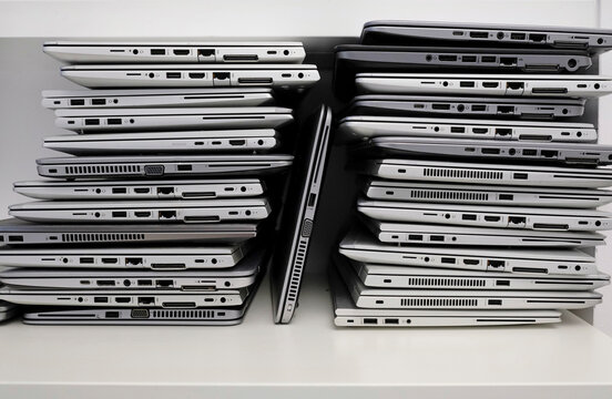 Rack with a stack of laptops in the storage room of a company