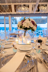 Elegant wedding table setting with floral centerpiece and candles