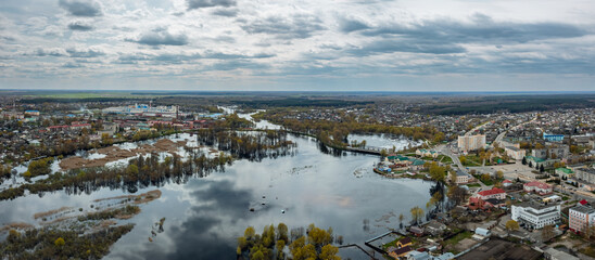 Aerial view vibrant urban landscape with water and overcast sky blending city and nature beautifully